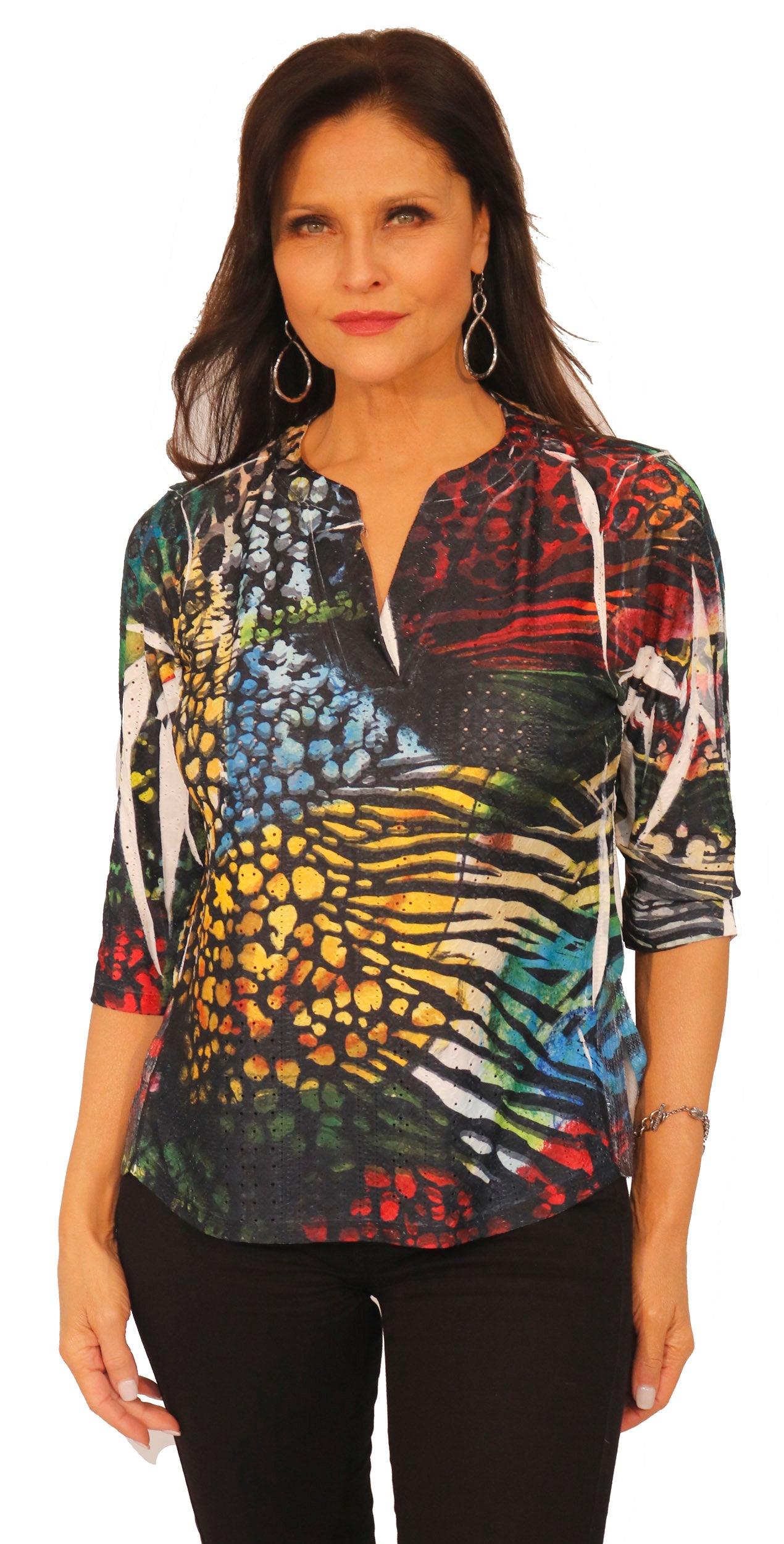 Impulse California women's 3/4 sleeve mandarin collar V-neck with sequin detail on the side of the hem. Unique black spots over a vibrant floral design. Made in the USA.