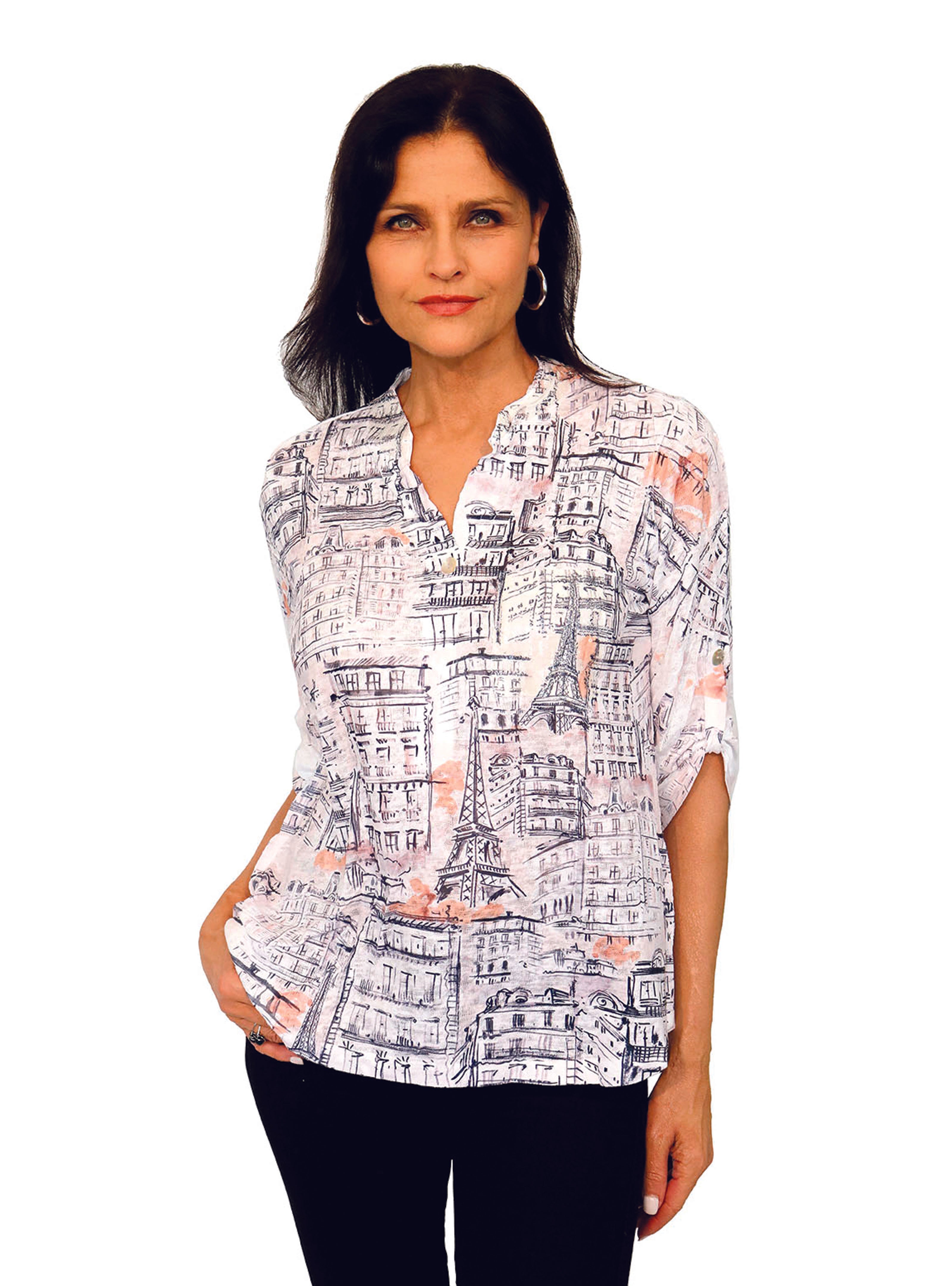 Impulse California women's mandarin collar top imprinted with the Eiffel tower and other Paris like buildings against a white background and a sunset color cloud among the buildings.